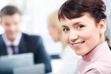 Wall Mural - Close-up of happy businesswoman looking at camera