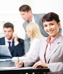 Wall Mural - Portrait of elegant female sitting at workplace