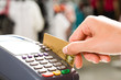 © pressmaster - Close-up of hand holding plastic card in payment machine