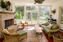 Screen Porch With Fireplace And Wicker Furniture