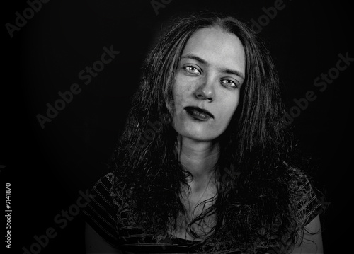 Obraz na plátně Dark Image of a Tired Depressed Woman on Black Background