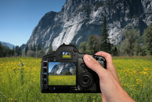 Tourist Taking A Photograph Of Mountains In Yosemite