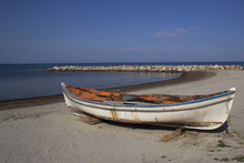 An Old Boat On A Sand Beach