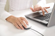 feminine hands typing on laptop keyboard