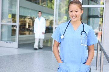 A pretty woman nurse outside hospital office building