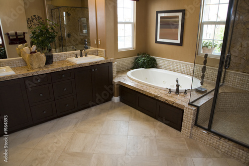 Fotografia, Obraz Spacious bathroom with a modern tub and tile floor.