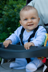 Sticker - smiling baby boy in a pram outdoor