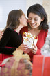 © Monkey Business - Girl Surprising Her Mother With Christmas Gift