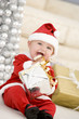 © Monkey Business - Baby In Santa Costume At Christmas