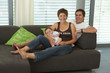 © amriphoto.com - baby with parents on sofa at home
