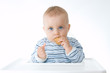© Renata Osinska - cute baby boy eating biscuits, on white