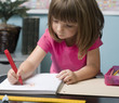 © BCFC - Young child working at her desk in class room