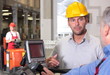 © endostock - supervisor  talking to forklift operator in warehouse