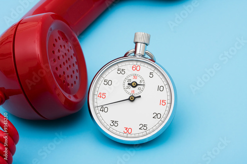 Fotografie, Obraz Stop watch with telephone – very quick response time