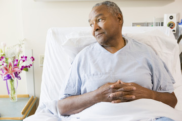 Wall Mural - Senior Man Sitting In Hospital Bed