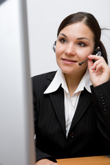 Canvas Print - happy businesswoman at desk with headphone