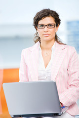 Poster - Young attractive business woman working on laptop