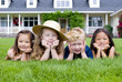 © Thomas Perkins - A group of kids laying in the grass. Diveristy and friendship