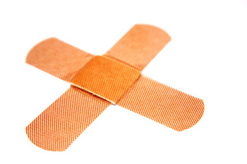 Two crossed bandages on white background