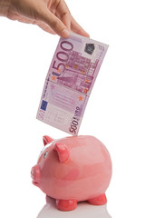 Wall Mural - Saving a note of five hundred euros in a piggy-bank isolated