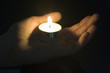 © Monkey Business - Close-Up Of Candle In The Palm Of A Persons Hand
