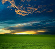 canvas print picture An image of green field under dramathic sky