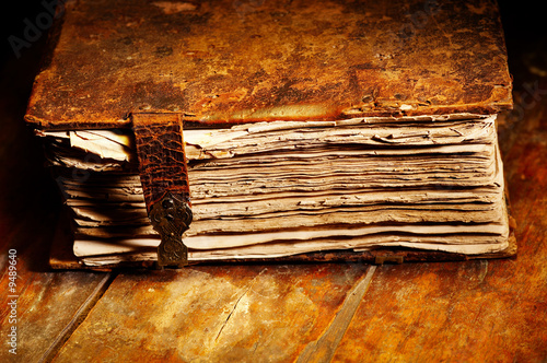 Naklejka ścienna Old shabby book in leather cover