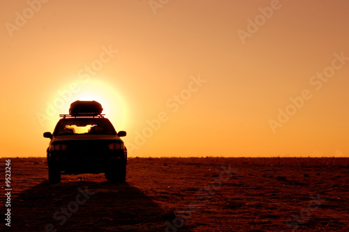 Fotografie, Obraz Offroad 4x4 vehicle in the desert at sunrise