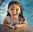 © BCFC - Little girl with pretty smile playing in swimming pool
