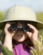© BCFC - Young child looking through toy binoculars wearing safari hat