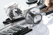 Financial health , stethoscope aroundcoins and calculator