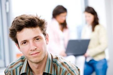 Poster - Young happy businessman looking at camera,