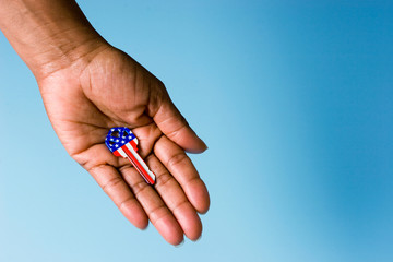 House key with American flag in hand on blue background