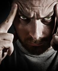 Close-up portrait of scary man looking very stressed and upset