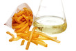 French Fries and Beaker full of liquid trans fat on white ground