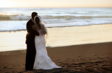 Couple wedding on the beach at sunset