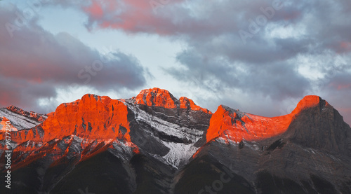 Naklejka na szybę Tops of mountains sparkling by red morning color in Canada