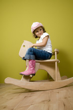 Little  Country Girl Playing With Rocking Horse