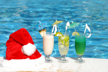 Santa hat and cocktails near the swimming pool