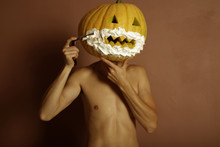 Surrealistic Portrait Of Young Man With Pumpkin On Head