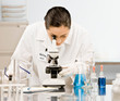© AVAVA - Research scientist in lab coat looking at specimen in laboratory