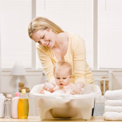 devoted mother give baby girl a bath