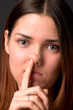 The girl picks a finger in a nose