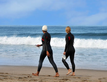 Two Sportswomen Walking  On The Beach