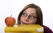 © Eric Simard - Close-up view of nerdy female student looking at apple.