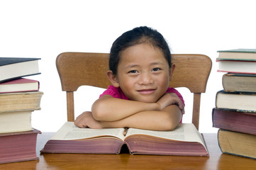 Wall Mural - A young asian school girl reading a book.