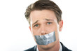© pressmaster - Face of man having his mouth closed with sellotape