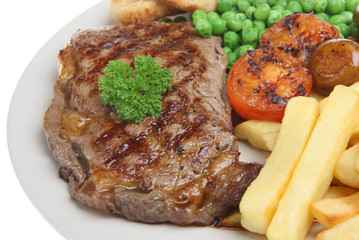 Canvas Print - Sirloin steak with chips, peas, tomato and onion rings