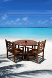 Fototapeta Do akwarium - Table and chairs on exotic beach