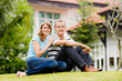 © EastWest Imaging - A young attractive couple sitting in garden of their house